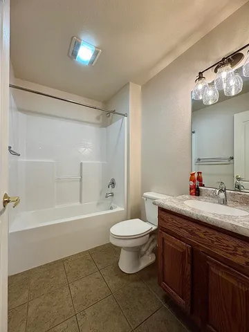 a bedroom with a bed and a desk