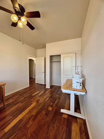 a view of a room with workspace and wooden floor