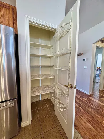 a view of walk in closet with empty racks