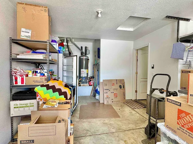 a garage filled with a white stove a refrigerator and a dining table