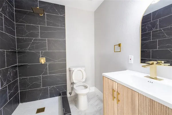 a bathroom with a sink toilet and shower