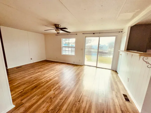 wooden floor in an empty room with a window