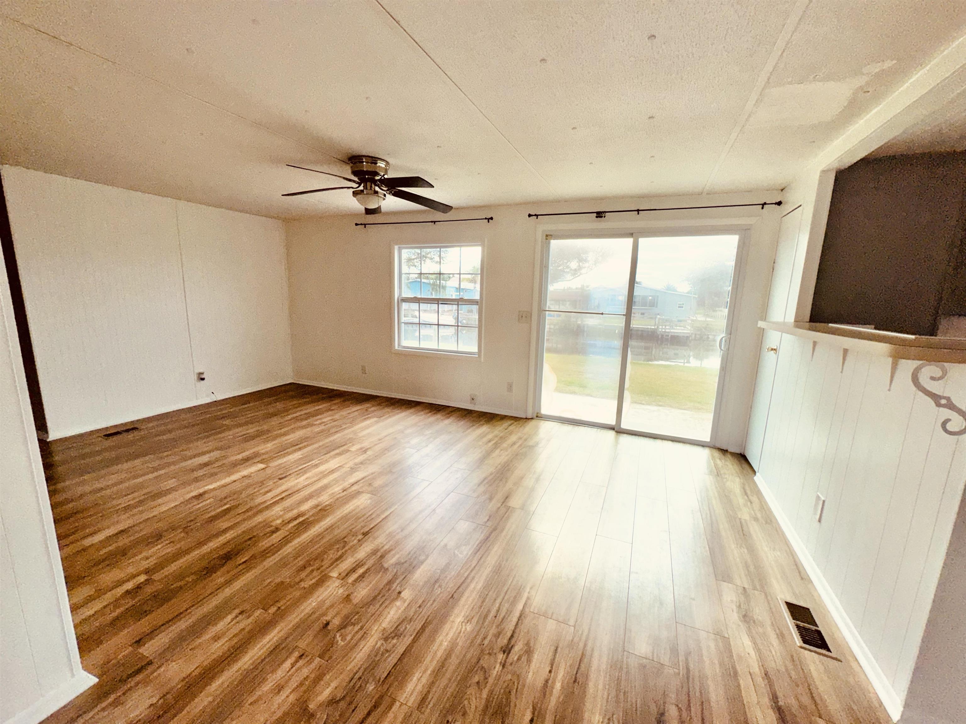 267 Basque Road St. Augustine, FL 32080 - Photo 12 of 20 wooden floor in an empty room with a window