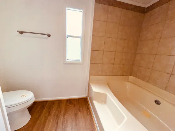 a bathroom with a bathtub and a toilet