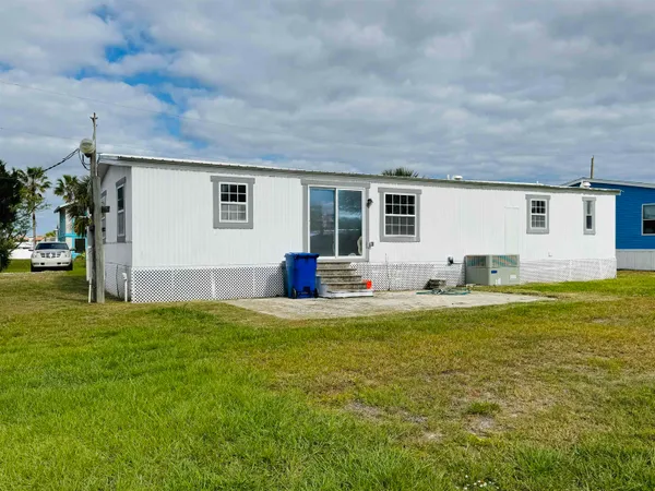 a view of a house with a backyard