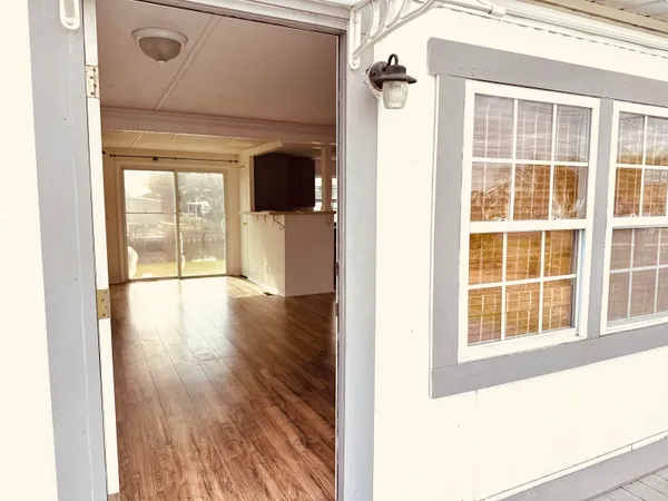 a view of an entryway with wooden floor