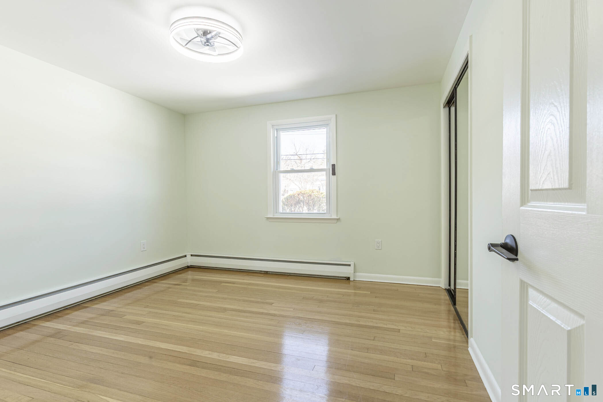 26 Kelly Road Hamden, CT 06518 - Photo 16 of 37 an empty room with wooden floor and windows