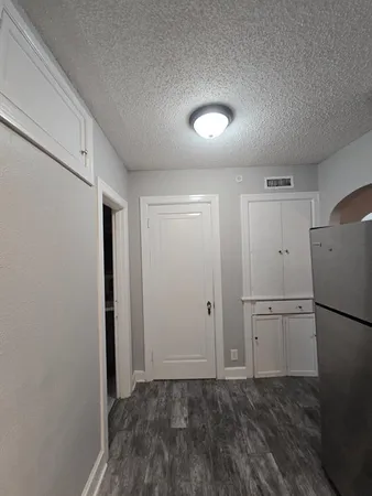 a view of a kitchen with a refrigerator and a stove