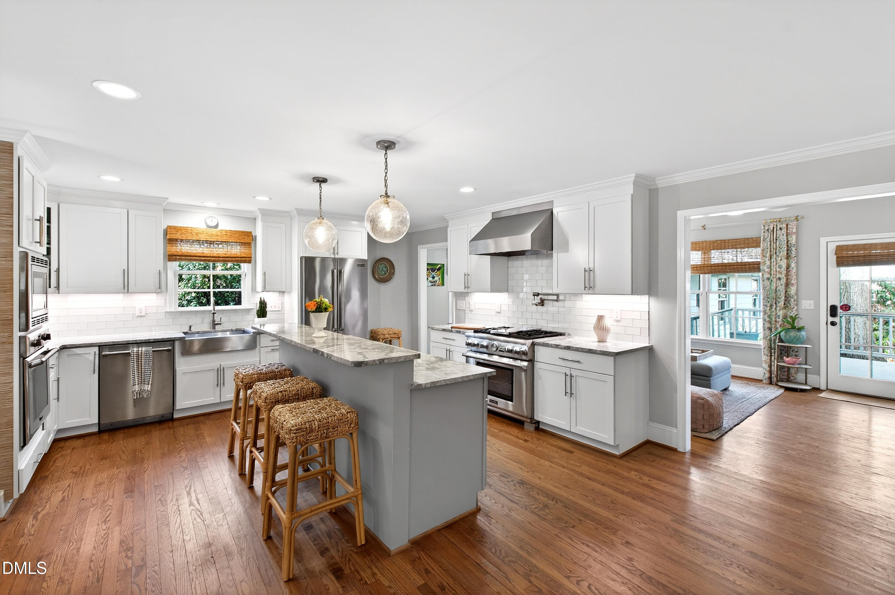 2622 Wells Avenue Raleigh, NC 27608 - Photo 23 of 65 a large kitchen with cabinets wooden floor and stainless steel appliances