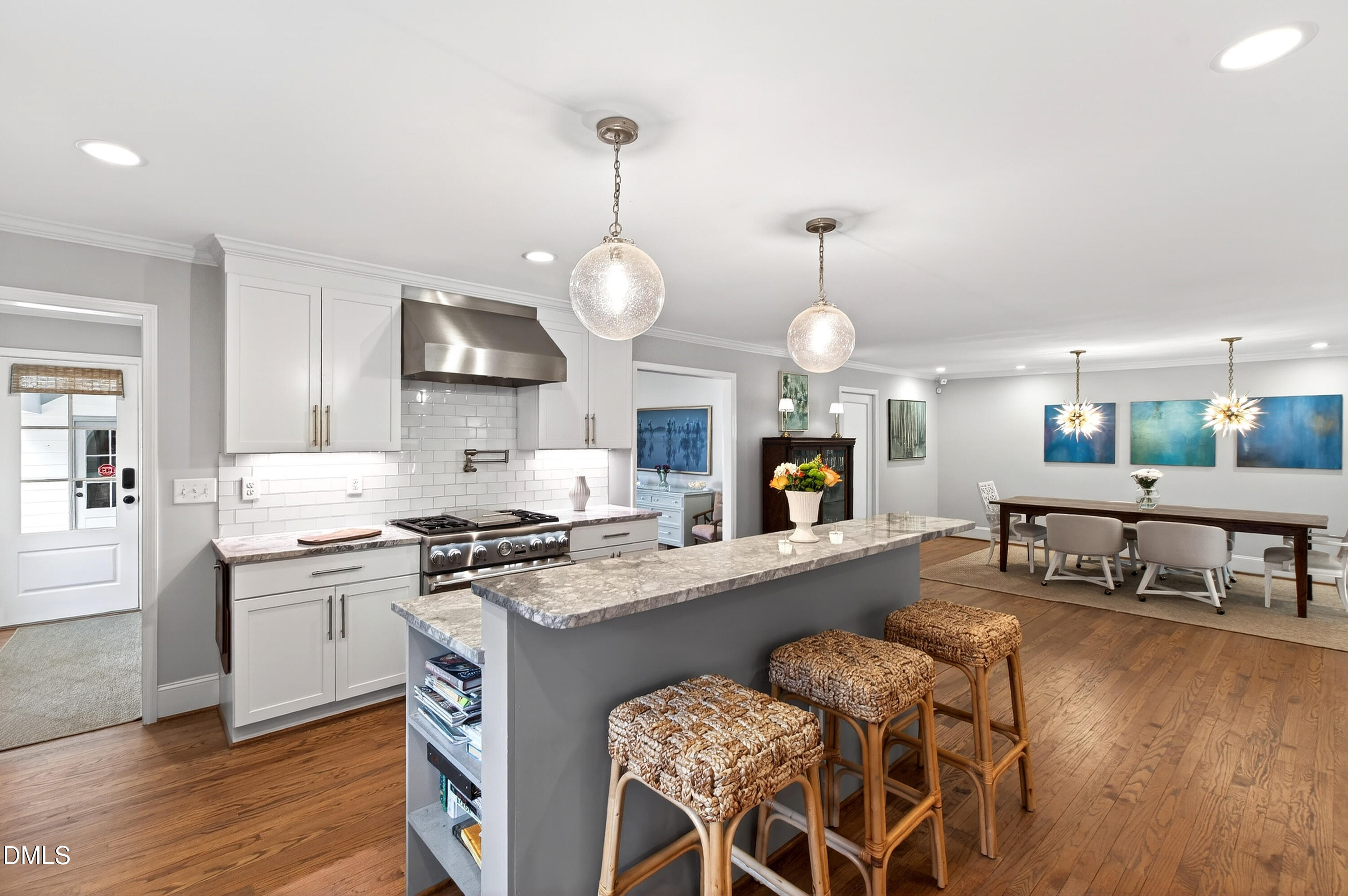 2622 Wells Avenue Raleigh, NC 27608 - Photo 27 of 65 a large kitchen with kitchen island a large island in the center and stainless steel appliances