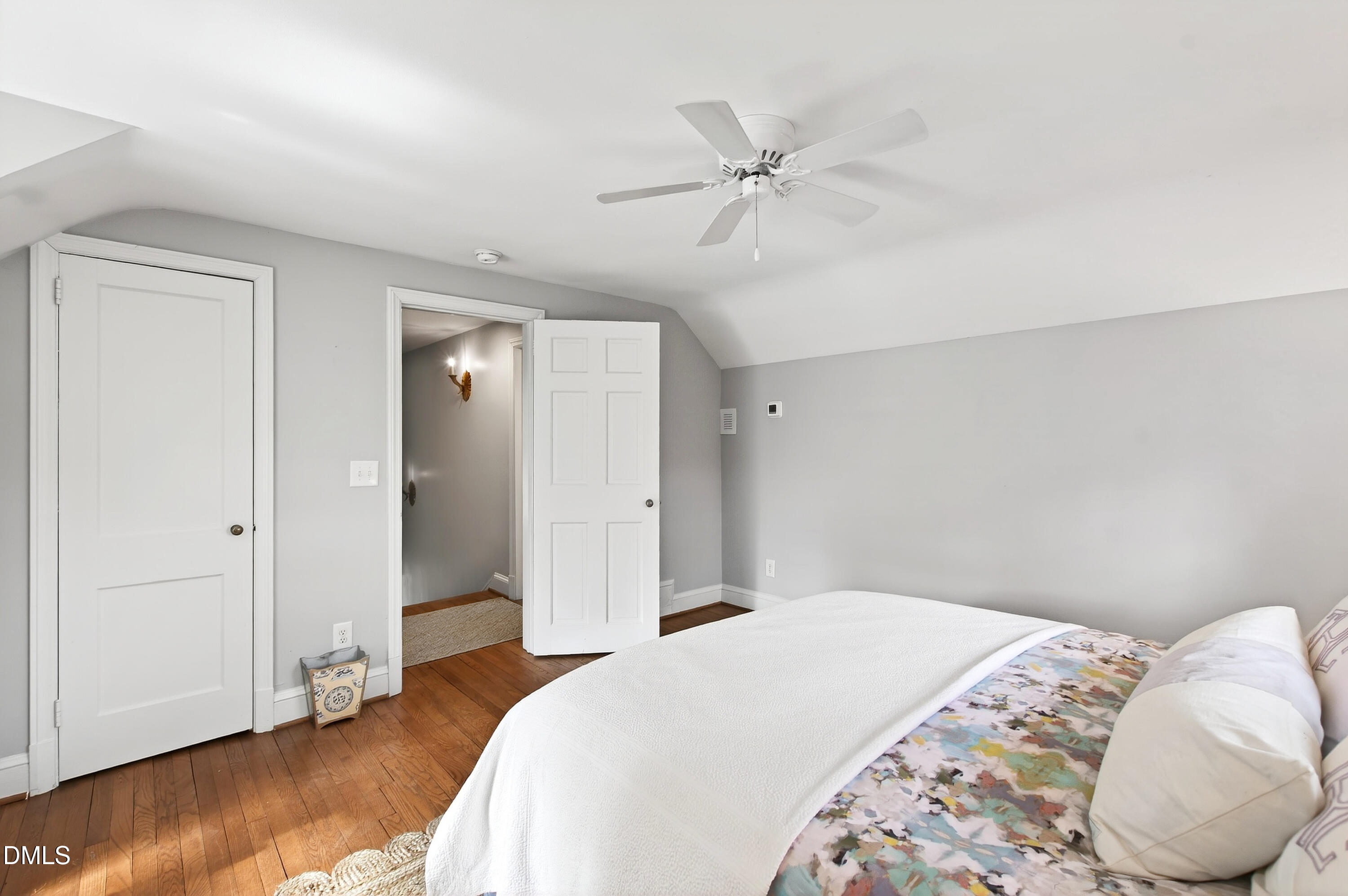 2622 Wells Avenue Raleigh, NC 27608 - Photo 45 of 65 a bedroom with a bed and a chandelier