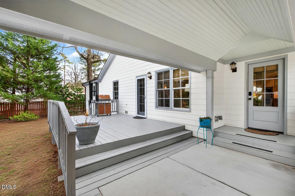 2622 Wells Avenue Raleigh, NC 27608 - Photo 57 of 65 a roof deck with table and chairs and wooden floor