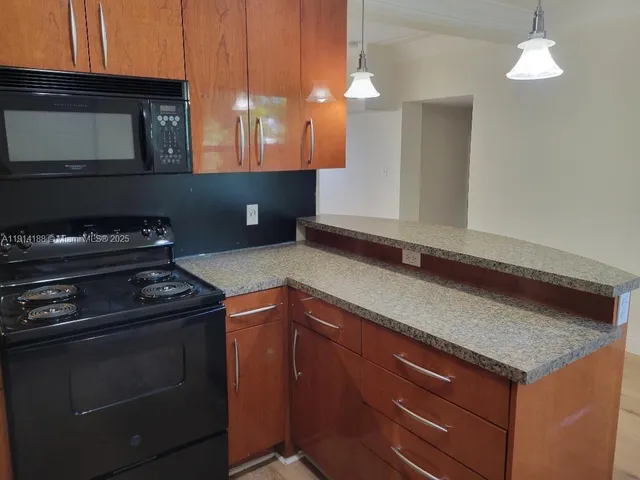 a kitchen with a stove and a microwave