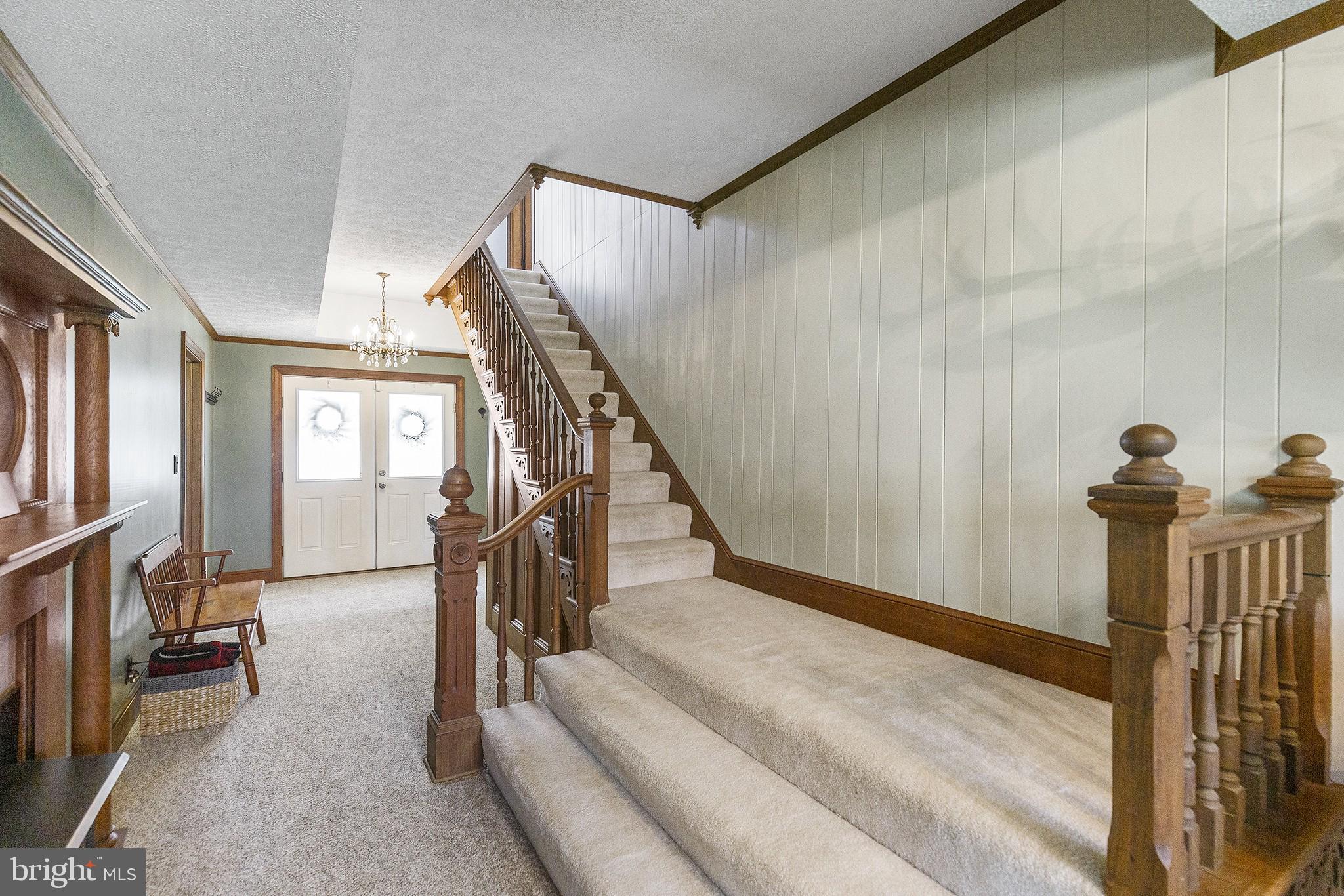 21400 Colton Point Road Avenue, MD 20609 - Photo 5 of 41 Foyer with gas log fireplace and stairway.