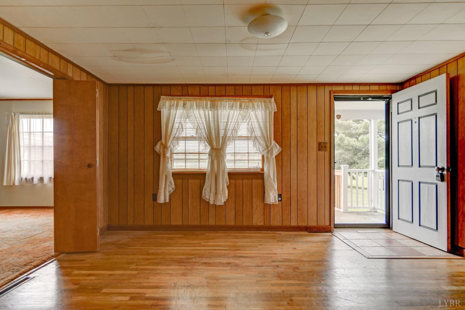2180 Moons Road Long Island, VA 24569 - Photo 5 of 41 a view of an empty room with window and wooden floor