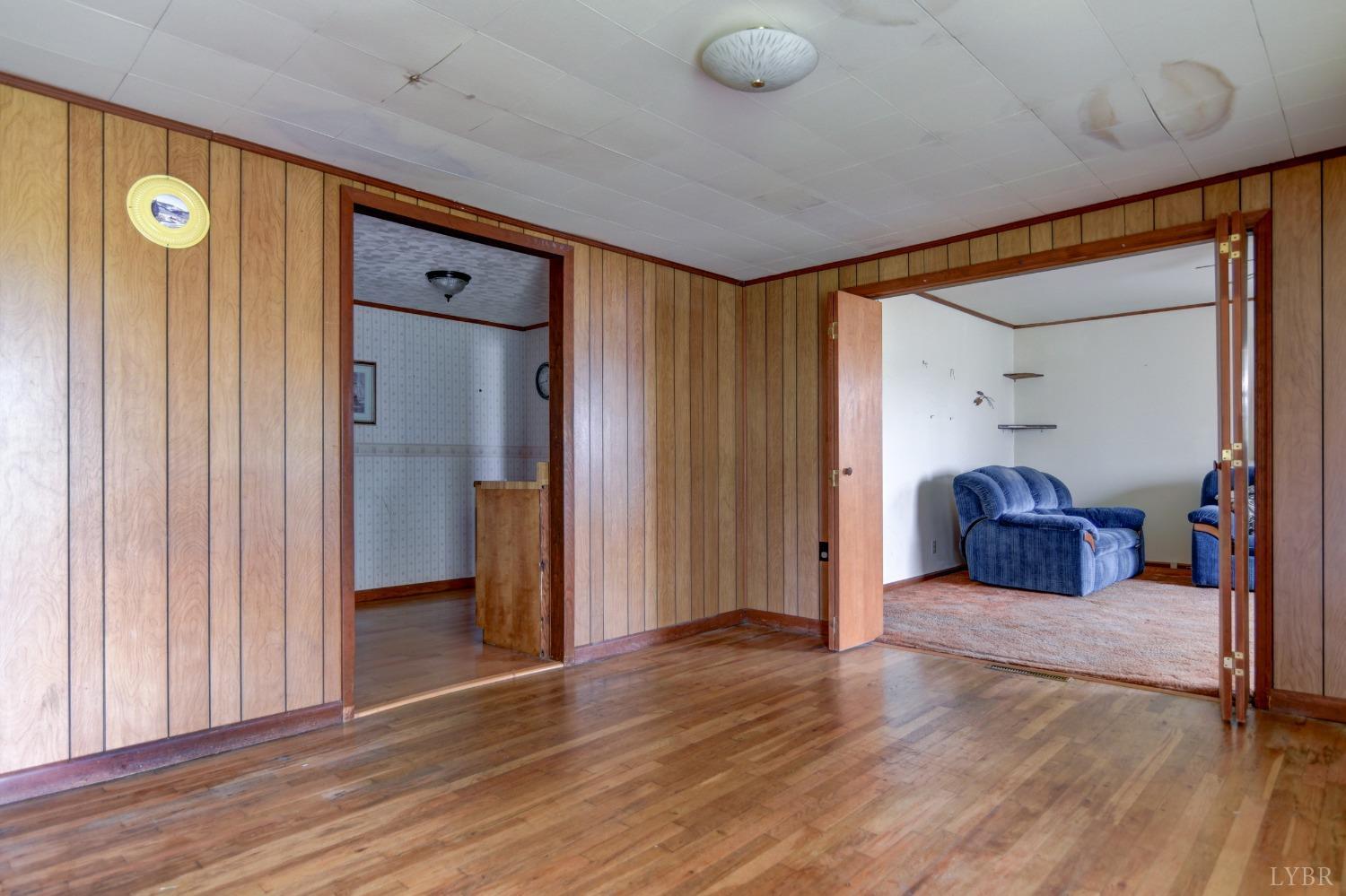 2180 Moons Road Long Island, VA 24569 - Photo 6 of 41 a view of a hallway with wooden floor and furniture
