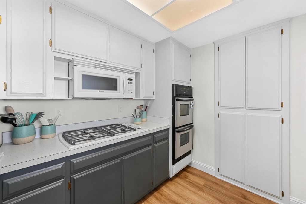 938 Doris Drive Encinitas, CA 92024 - Photo 11 of 31 a kitchen with stainless steel appliances granite countertop a sink stove and refrigerator