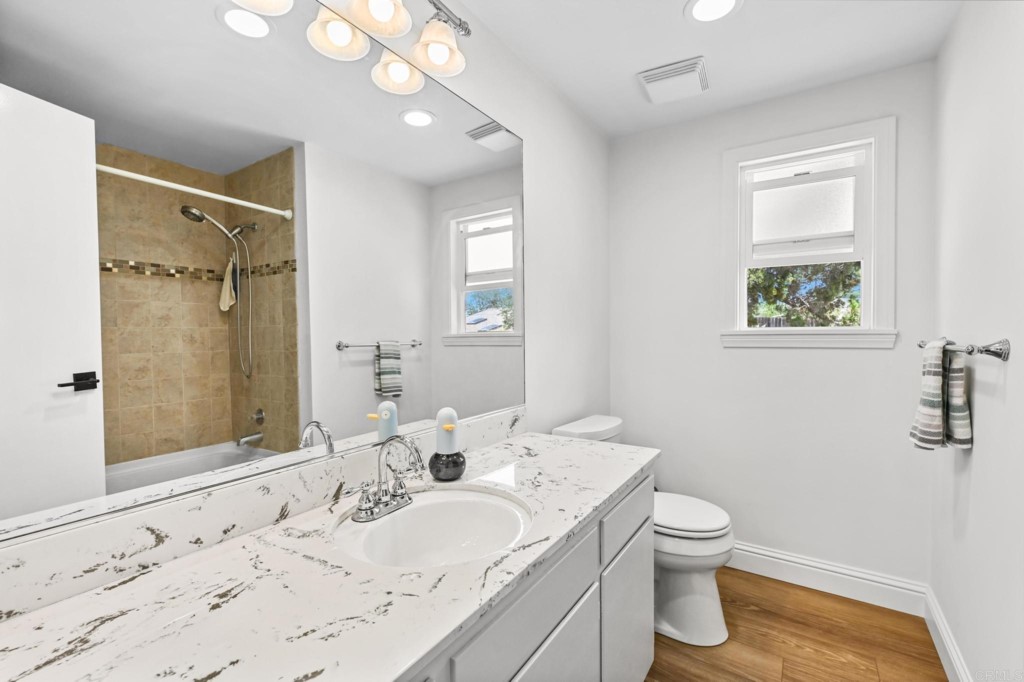 938 Doris Drive Encinitas, CA 92024 - Photo 14 of 31 a bathroom with a granite countertop sink toilet and shower