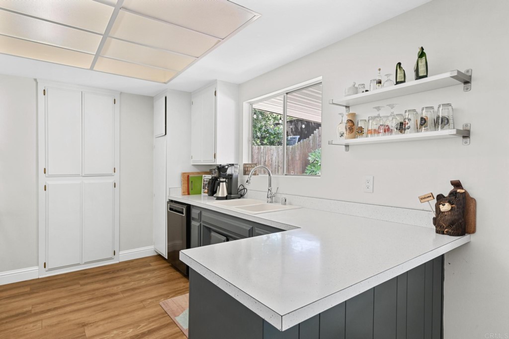 938 Doris Drive Encinitas, CA 92024 - Photo 7 of 31 a kitchen with a sink a stove and cabinets