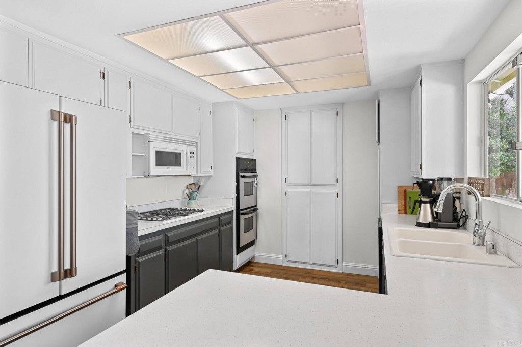 938 Doris Drive Encinitas, CA 92024 - Photo 8 of 31 a kitchen with stainless steel appliances a refrigerator and a stove top oven