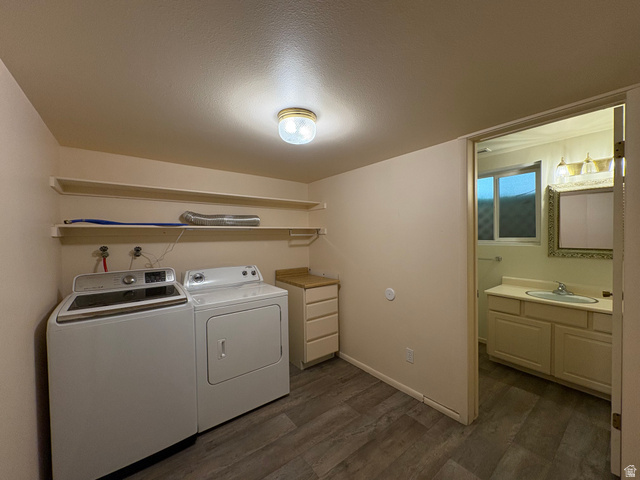 595 Meadowlark Road Orem, UT 84097 - Photo 59 of 87 Dedicated laundry area featuring wood-finish flooring, built-in shelving, and an adjacent bathroom with a vanity and mirror