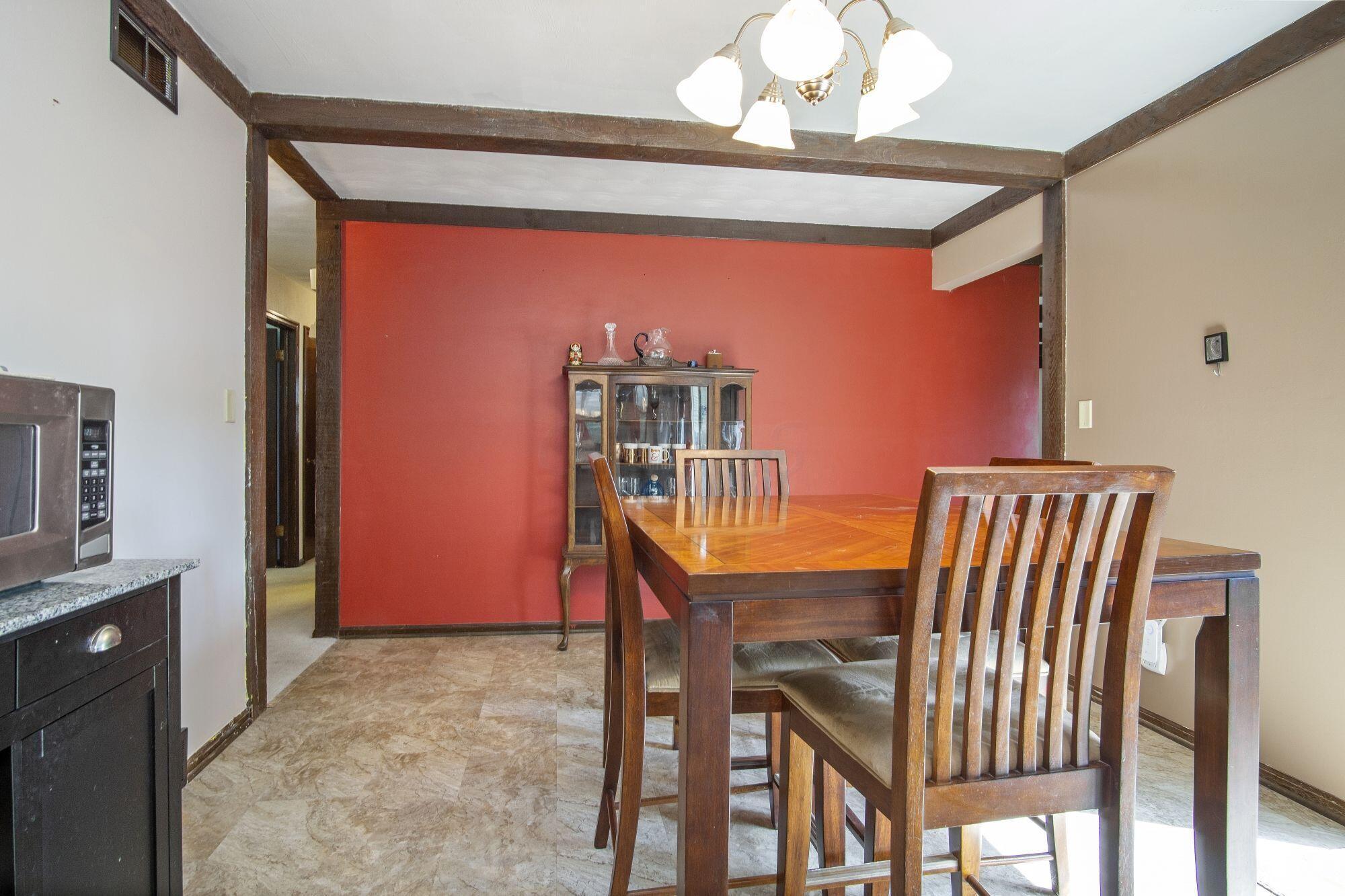 6053 Rocky Rill Road Columbus, OH 43235 - Photo 11 of 28 Formal Dining Room with beamed ceiling. New light fixture. New 2021 plank vinyl flooring.