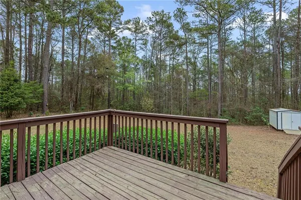 a balcony with wooden floor and fence