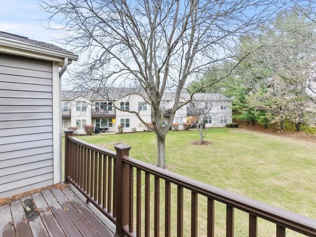 a view of balcony with wooden floor and fence