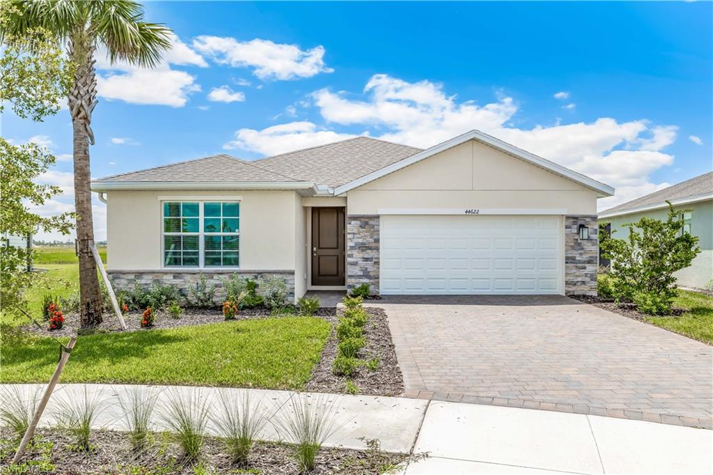 17770 Shade Tree Loop Punta Gorda, FL 33982 - Photo 1 of 47 a front view of a house with a garden and plants