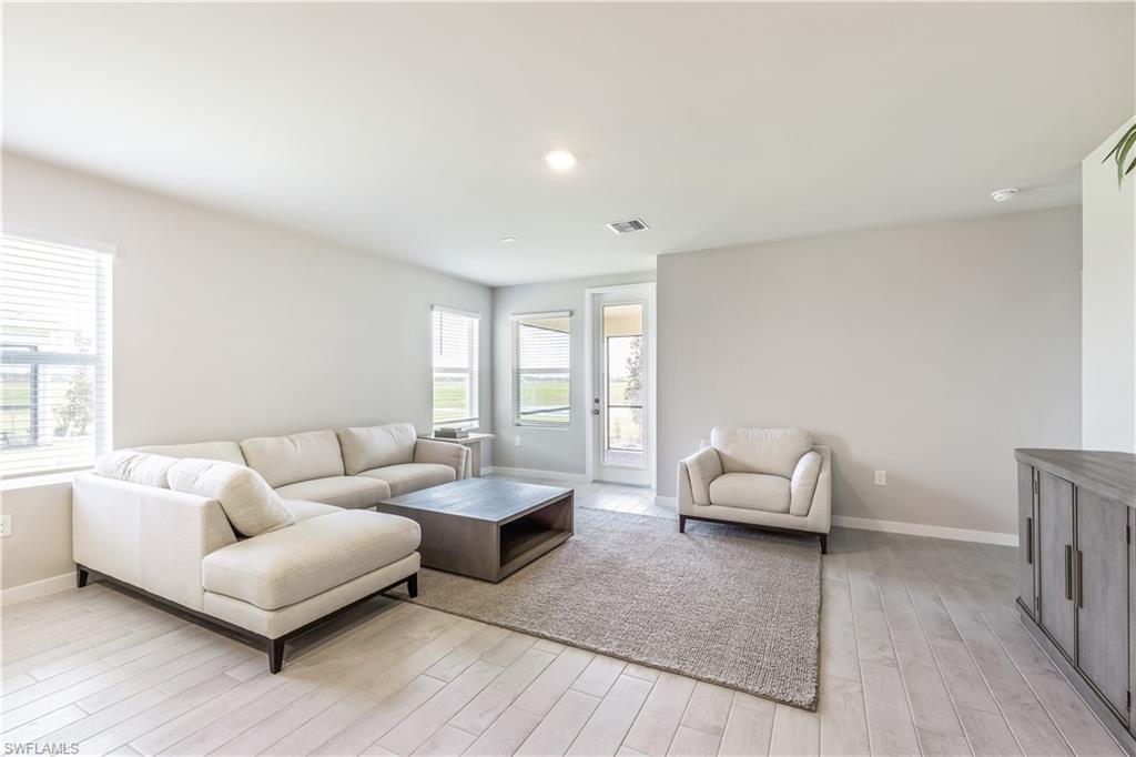 17770 Shade Tree Loop Punta Gorda, FL 33982 - Photo 2 of 47 a living room with furniture and wooden floor