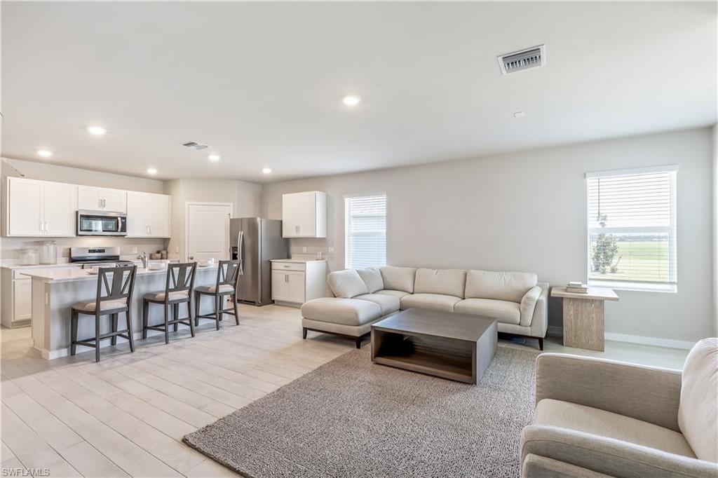 17770 Shade Tree Loop Punta Gorda, FL 33982 - Photo 3 of 47 a living room with furniture kitchen view and a wooden floor