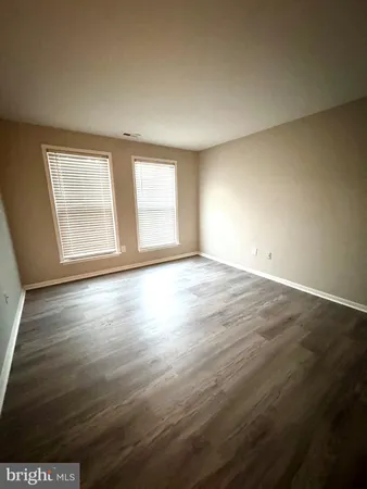 a view of storage and utility room with wooden floor