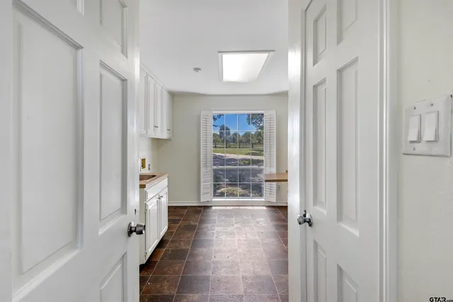 a view of a hallway with a white walls and stairs