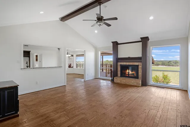 a view of an empty room with a fireplace and a window