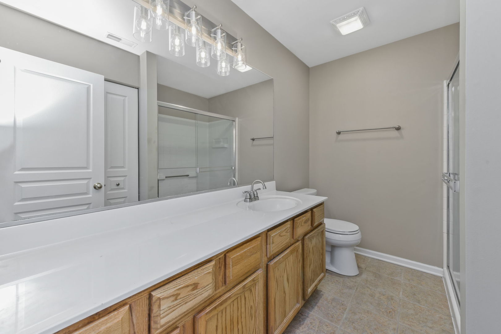 3142 Bromley Lane Aurora, IL 60502 - Photo 9 of 15 a bathroom with a granite countertop sink a toilet and shower