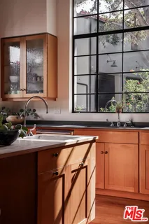 a living room with furniture floor to ceiling window and a flat screen tv