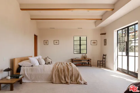 a view of a livingroom with furniture and a window
