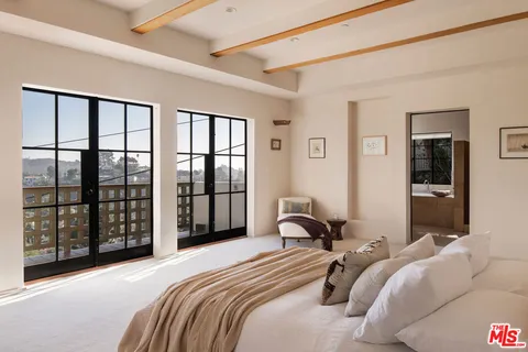 a bathroom with a tub and a sink next to a window