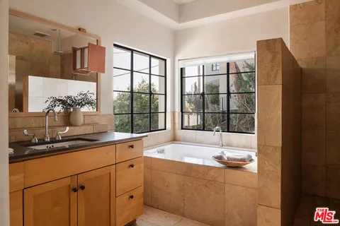 a bathroom with a sink and a large mirror