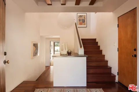 a living room with furniture window and wooden floor