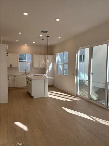 a open kitchen with stainless steel appliances granite countertop a refrigerator and a sink