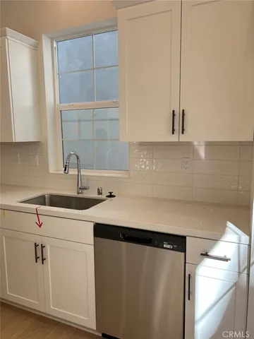 a kitchen with a sink and cabinets