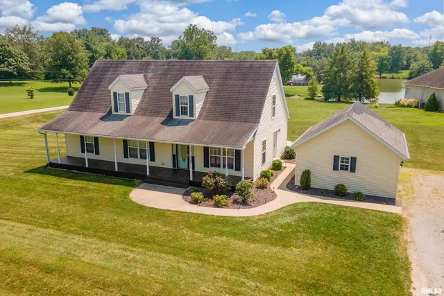 a aerial view of a house with swimming pool and a yard