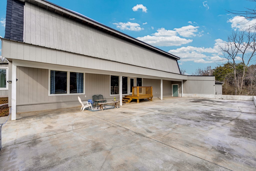 2165 Ben Mason Road Cookeville, TN 38506 - Photo 24 of 52 a backyard of a house with table and chairs and potted plants