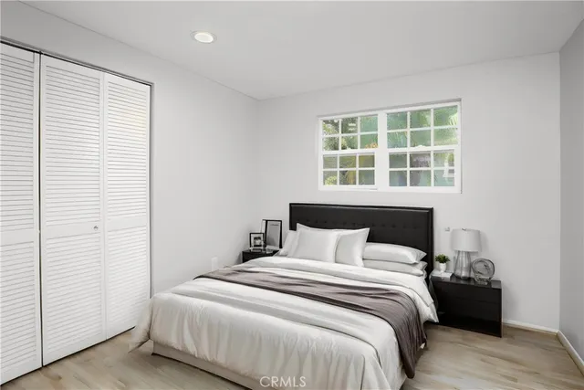 a bedroom with a bed and a window