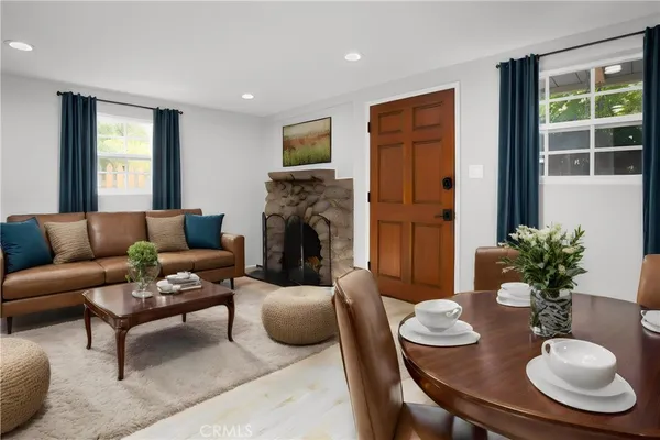 a living room with furniture potted plant and a fireplace