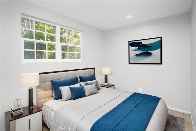 a bedroom with a bed and a window