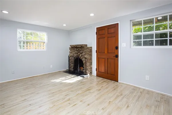 an empty room with windows and closet