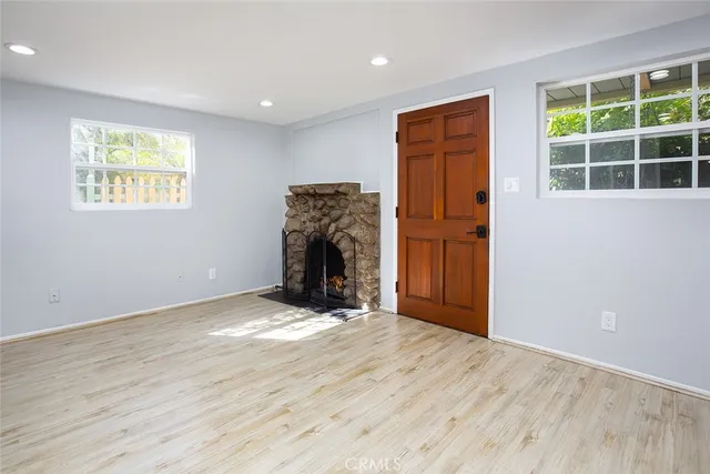 an empty room with windows and closet