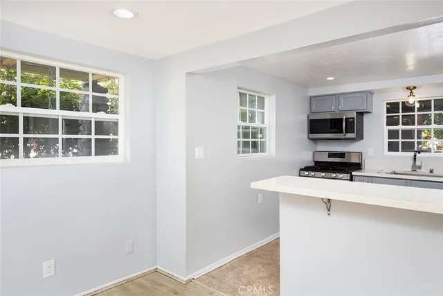a kitchen with a stove a microwave and a refrigerator